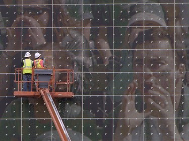 Work crews do last minute touch ups to the giant maxtron screen in the north end of Taylor Field at Mosaic Stadium in Regina, SK, June 21 2012.