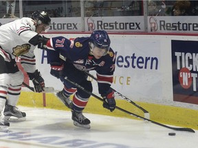 Pats Dawson Leedahl gets hooked by Portland's Alex Overhardt during WHL action between the Regina Pats and the Portland Winterhawks at the Brandt Centre in Regina Wednesday night.