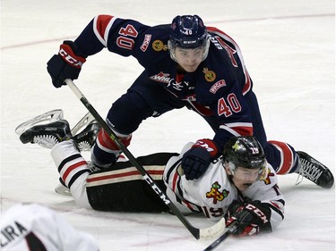 Pats Riley Bruce takes down Portland's Ryan Hughes during WHL action between the Regina Pats and the Portland Winterhawks at the Brandt Centre in Regina Wednesday night.