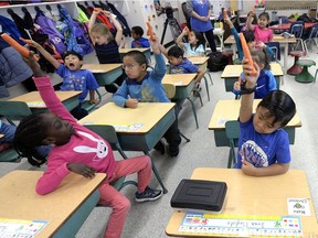 Grade 1 students at St. Catherine School bite down on carrots as part of The Big Crunch.