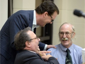 Candidates for the Mayor's job in this year's civic election took part in a forum at the Cathedral neighbourhood centre Thursday night. Incumbent Michael Fougere, (standing) chats with Tony Fiacco,(left) and Jim Elliott before the start of the forum.