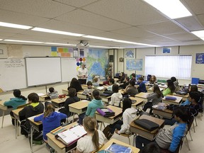 Saskatchewan students at work. The province is pondering further amalgamation of school divisions to save money.
