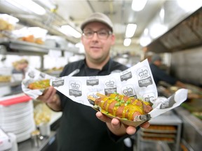 Sean Hale, executive chef at Victoria's Tavern holds up a white bean and lentil vegetarian corn dog at Victoria's Tavern in Regina, Sask. on Saturday Oct. 22, 2016. The pub will compete in the Great Canadian Pulse Off restaurant challenge next week.