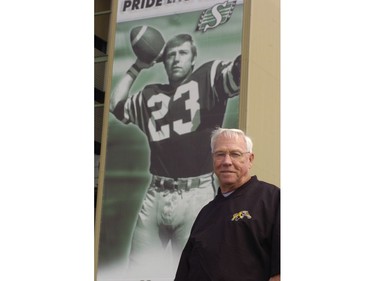Photos of Hamilton Head coach Ron Lancaster in front of a giant poster of him in his playing days in front of Taylor field. 2