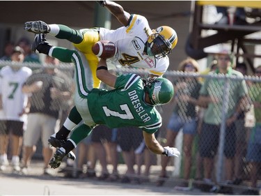 Edmonton Eskimos' Jason Goss (4) gets called for pass interference in the endzone as he brings down Saskatchewan Roughriders Weston Dressler (7) in second half CFL action at Mosaic Stadium in Regina, Sask. on Saturday, July 25, 2009.