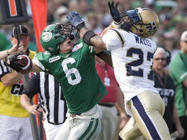 Saskatchewan Roughriders Rob Bagg (6) and Winnipeg Blue Bombers' Lenny Walls (27) get their hands up in each others face masks in first half CFL action at Mosaic Stadium on Sunday, Sept. 6, 2009, in Regina, Sask.