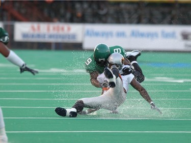 Saskatchwan's Reggie Hunt and B.C.'s Ryan Thelwell splash down after an incomplete pass.
