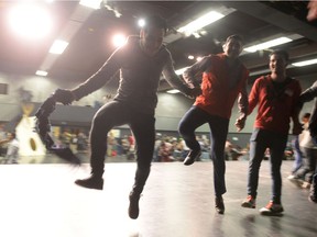 Syrian men dance at a newcomer event organized by the Regina Region Local Immigration Partnership held at the Regina Performing Arts Centre in Regina, Sask. on Saturday Oct. 15, 2016.