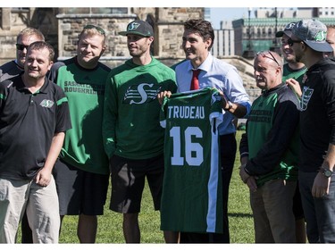 The Saskatchewan Roughriders practiced on Parliament Hill in Ottawa on Tuesday October 11, 2016. Prime Minister Justin Trudeau dropped by and was presented with a jersey by the team. Errol McGihon/Postmedia ORG XMIT: POS1610111501391893