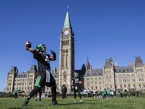 Saskatchewan Roughriders quarterback Darian Durant, who is hoping to become a Canadian citizen, throws a pass on Parliament Hill on Oct. 11.