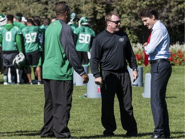 The Saskatchewan Roughriders practiced on Parliament Hill in Ottawa on Tuesday October 11, 2016. Prime Minister Justin Trudeau chats with head coach Chris Jones (middle). Errol McGihon/Postmedia ORG XMIT: POS1610111501461898