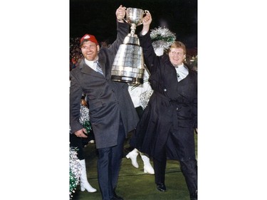 Gull Lake-area native Roger Aldag (right) and Bob Poley hoist the Grey Cup during a 1989 celebration at Taylor Field.