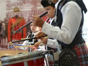 The youngest member of the University of Regina Conservatory of Performing Arts Pipe Band Alyssa Rosnes (center) plays during a Culture Days event called Music, Marching and Mounties at the RCMP Heritage Centre in Regina, Sask. on Saturday Oct. 1, 2016.