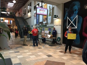 Bill Whatcott (in red at centre) engages passer-by at his display set up in the University of Regina on Tuesday, Oct. 18, 2016.