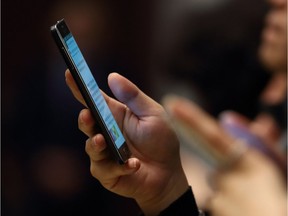 Shareholders use their Samsung smartphones during the company's extraordinary general meeting of shareholders at the Seocho office building in Seoul on October 27, 2016. AFP PHOTO / POOL / SeongJoon ChoSEONGJOON CHO/AFP/Getty Images