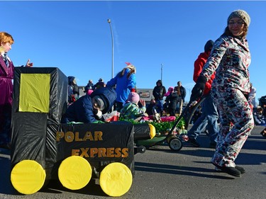 A boy has a nap while being pulled in a wagon at the Santa Claus Parade held on South Albert St. in Regina, Sask. on Sunday Nov. 20, 2016.