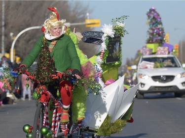 A woman rides a bike at the Santa Claus Parade held on South Albert St. in Regina, Sask. on Sunday Nov. 20, 2016.