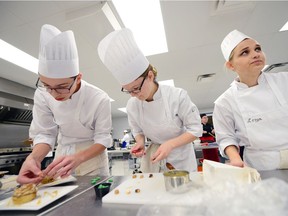 Brendan Bobryk, left, Erin Leigh, center and Lesya Ochitwa, right, work to finish their team's dessert at the first annual RCSD Cooking Competition held at Miller High School in Regina, Sask. on Saturday Nov. 19, 2016. Eight teams of four students from Grades 11 and 12 were evaluated by local chefs.