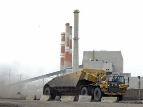 A coal hauler drives past SaskPower's Boundary Dam Power Station near Estevan.