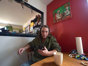 Dan Lindsay speaks on his cell phone to Pura Fé at his home in Regina, Sask. on Sunday Nov. 6, 2016. Lindsay supports the Standing Rock protests against the Dakota Access Pipeline.