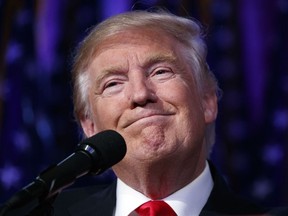 U.S. President-elect Donald Trump smiles as he arrives to speak at an election night rally, early on Wednesday, Nov. 9, 2016, in New York.