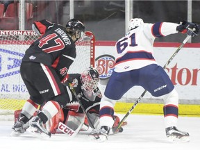Filip Ahl of the Regina Pats fights for a loose puck in front of Moose Jaw Warriors goaltender Zach Sawchenko on Thursday at Mosaic Place.