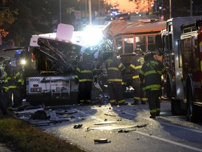 Fire department and rescue officials are at the scene of an early morning fatal collision between a school bus and a commuter bus Tuesday, Nov. 1, 2016, in Baltimore. (Jeffrey F. Bill/Baltimore Sun via AP) ORG XMIT: MDBAE101