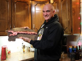 Jeff Woodward shows off a pig spleen during a pig spleen prognostication party in Gull Lake