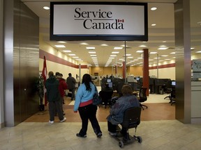 A line forms at a Service Canada office in Toronto to access a wide range of programs and services, including Employment Insurance.