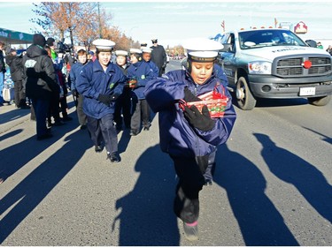 Navy cadets run around giving away candy at the Santa Claus Parade held on South Albert St. in Regina, Sask. on Sunday Nov. 20, 2016.