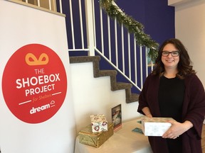 Carli Brundige-Gotchia, marketing manager at Dream holding one of the donated shoeboxes