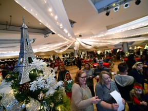 People participate in a scavenger hunt at the "Christmas in Paris" themed Festival of Trees on Nov. 13.
