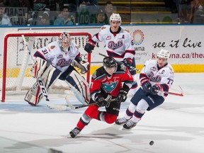 Rodney Southam #17 of the Kelowna Rockets is stick checked by Adam Brooks #77 in front of the net of Tyler Brown #31 of the Regina Pats during overtime on November 26, 2016 at Prospera Place in Kelowna, British Columbia, Canada.