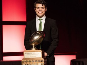 University of Regina Rams quarterback Noah Picton poses with the Hec Crighton Trophy in Hamilton on Thursday.