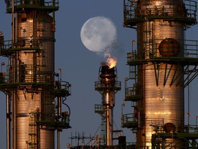 Heat wave distortion from a flare stack at the C0-op Refinery Complex travels through the supermoon in Regina.
