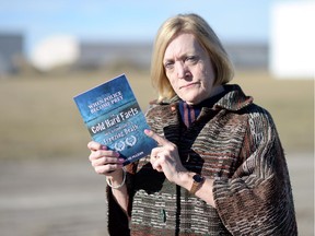 Candis McLean, author of When Police Become Prey, holds a copy of her book when in Regina last fall for a promotion tour that met with protest.