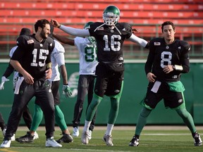 Quarterbacks G.J. Kinne (15), Brandon Bridge (16) and Mitchell Gale (8) of the Saskatchewan Roughriders work out during the CFL team's practice Thursday at Mosaic Stadium.