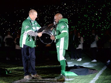 REGINA, SASK :  October 29, 2016  -- Roughriders legend   Gene Makowsky, left, hands Darian Durant the Grey Cup during the post game show following the Saskatchewan Roughriders final home game at old Mosaic Stadium in Regina. TROY FLEECE / Regina Leader-Post