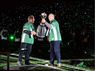 REGINA, SASK :  October 29, 2016  -- Roughriders legend   Roger Aldag hands Gene Makowsky the Grey Cup during the post game show following the Saskatchewan Roughriders final home game at old Mosaic Stadium in Regina. TROY FLEECE / Regina Leader-Post