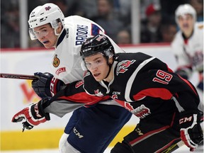 Adam Brooks (L) with the Regina Pats and Braydon Point (R) with the Moose Jaw Warriors during WHL hockey action at the Brandt Centre in Regina on March 11, 2016.