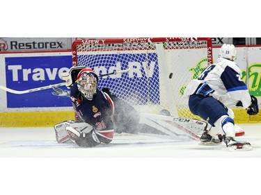 Braylon Shmyr (R) with the Saskatoon Blades scores on Regina Pats goalie Tyler Brown during a Western Hockey League game at the Brandt Centre in Regina.