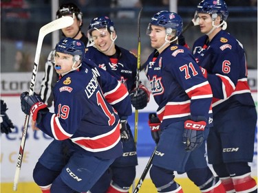 Regina Pats, Jake Leschyshyn (L) after scoring on Saskatoon Blades net-minder Brock Hamm during a Western Hockey League game against the Saskatoon Blades at the Brandt Centre in Regina.