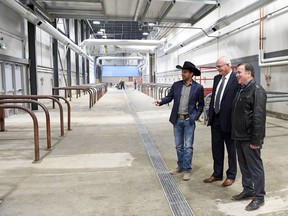 From left, Chris Lane, CWA CEO, Saskatchewan Agriculture Minister Lyle Stewart and Mark Allan, REAL president & CEO looking over the cattle washing station during an update on construction activity for the International Trade Centre and how the partially constructed facility will be used for 2016 Agribition.