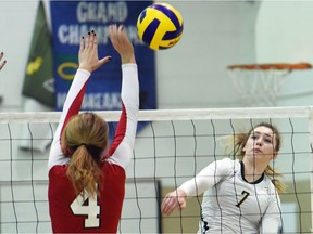 Brianna Stene, left, of the Prince Albert Carlton Crusaders attempts to block a spike by the Campbell Tartans' Hannah Toews on Friday during the Saskatchewan High Schools Athletic Association 5A girls volleyball championship at Campbell Collegiate.