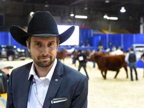 Canadian Western Agribition CEO, Chris Lane with the Red Angus show in the background at the CWA in Regina.