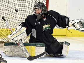 University of Regina Cougars goaltender Jane Kish makes a blocker save during a practice at the Co-operators Centre. Kish is getting into more games with the women's hockey team this season after playing sparingly last season.