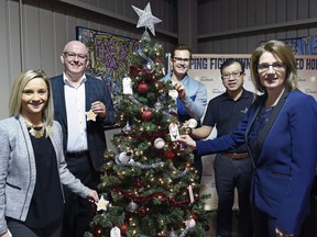 The launch of the Regina Food Bank's 12 Days of Christmas campaign shows from left, Megan Dunn - Sherwood Co-op, Regina Food Bank CEO Steve Compton, Wes Filson - Jump.ca, Phong Le - Good Earth Coffee Shop and Rhonda Speiss with PotashCorp during the launch of the Christmas campaign.