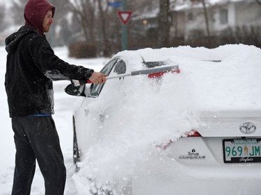 Chad Gratias cleans snow of his car in east Regina after a late November snowfall.