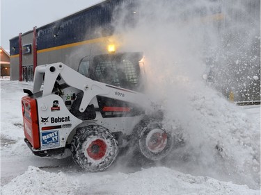 Work crews from Sauer Enterprises make short work of the snow on the 400 block of Park Street in Regina.