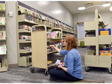 Pam Fingas sorting books at the rebuilt George Bothwell branch public library in the Southland Mall in Regina.